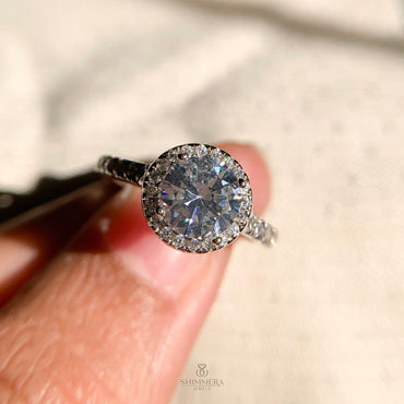 “Elegant white gold round halo engagement ring with 1.0 ct diamond center”