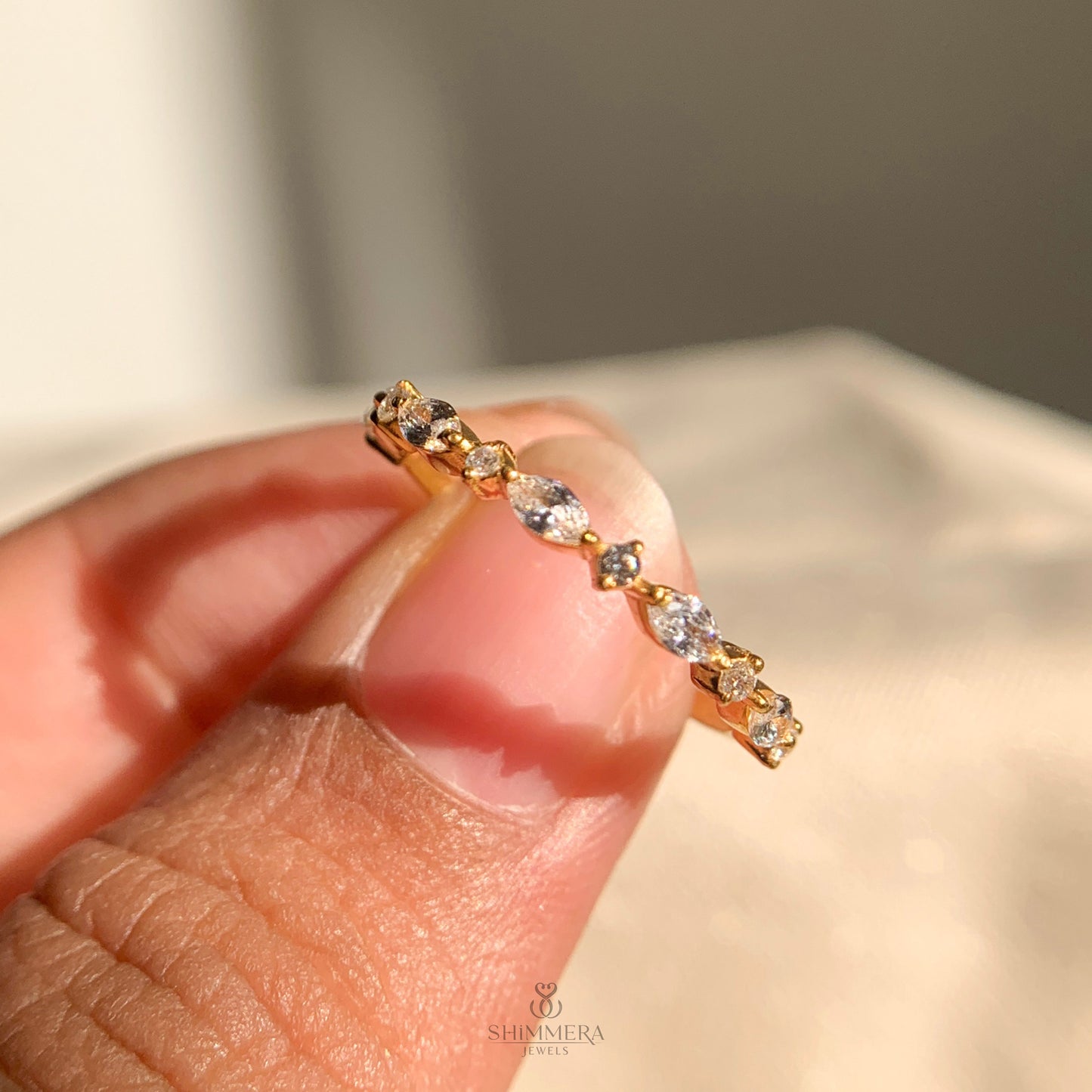 Women’s diamond half eternity band with alternating marquise and round stones
