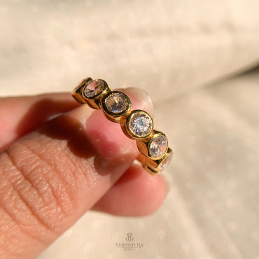 “Classic bezel setting with sparkling round diamonds on a sleek wedding band”