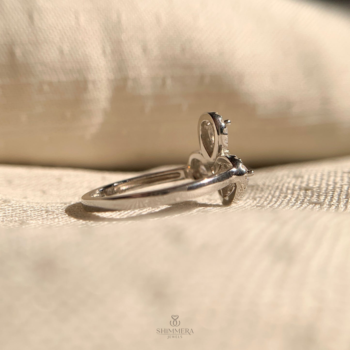 Ethical three stone pear shaped diamond halo ring for modern brides