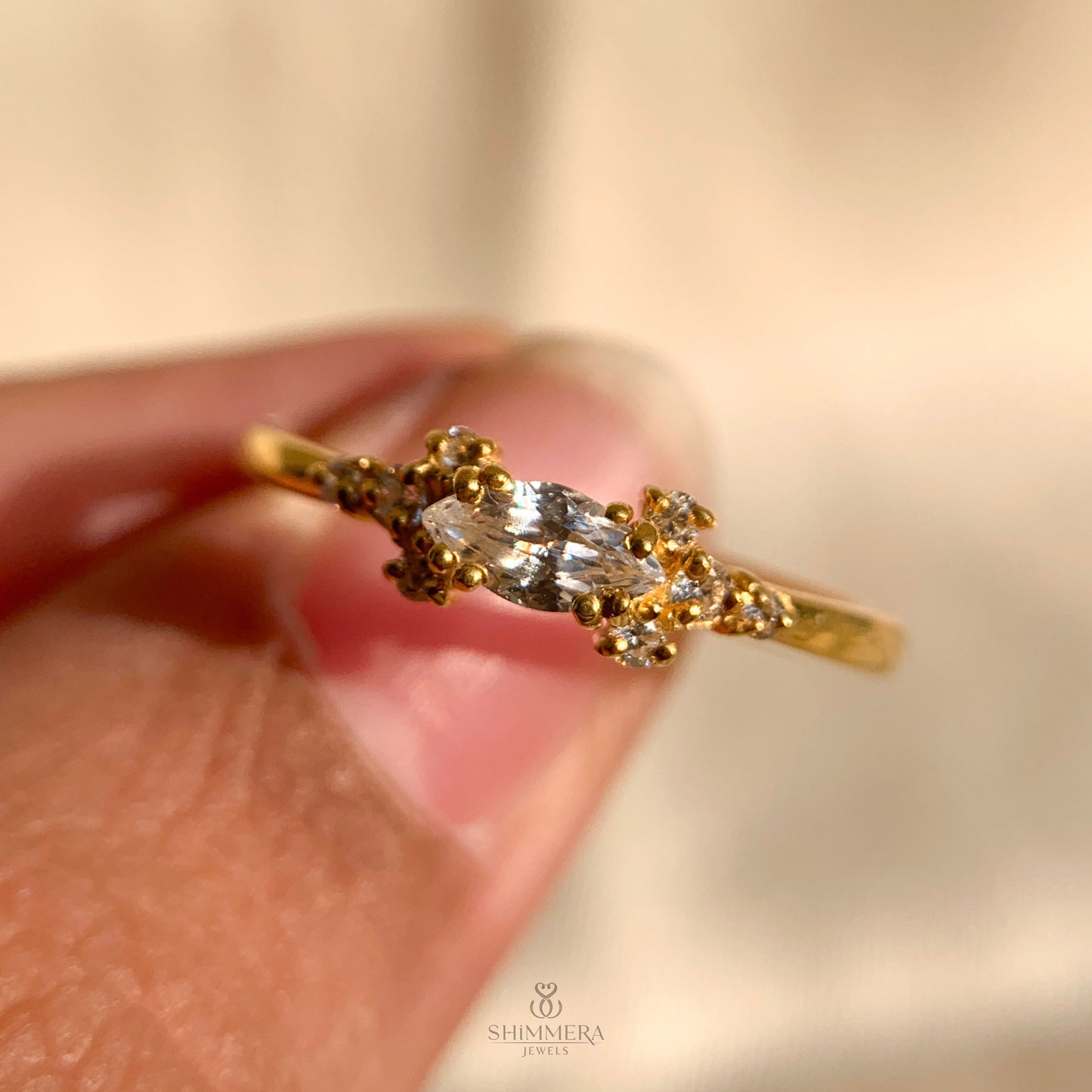 Solitaire engagement ring with sparkling marquise diamond side stones