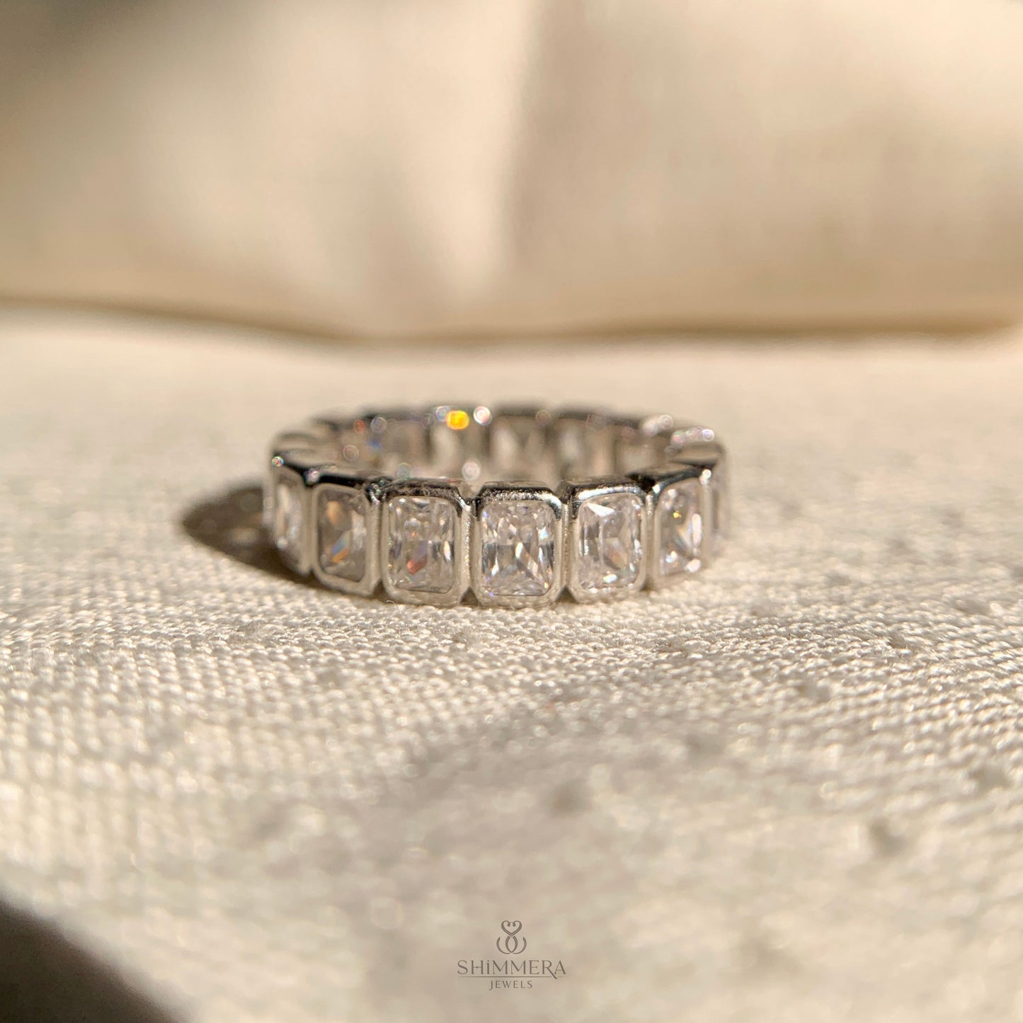 Elegant diamond bezel set wedding band with radiant cut stones