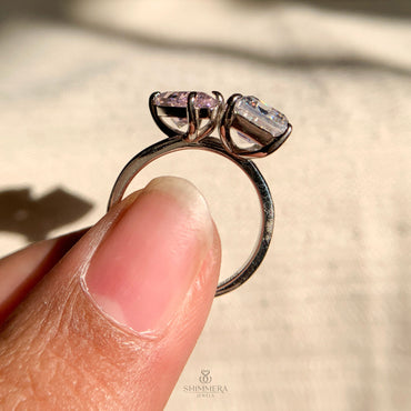 Modern double diamond engagement ring featuring emerald and pear cuts