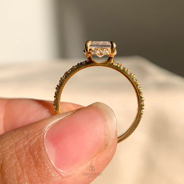 Sparkling radiant moissanite ring featuring a concealed halo setting