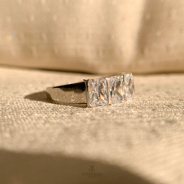 "Elegant emerald cut half eternity ring with scalloped design"