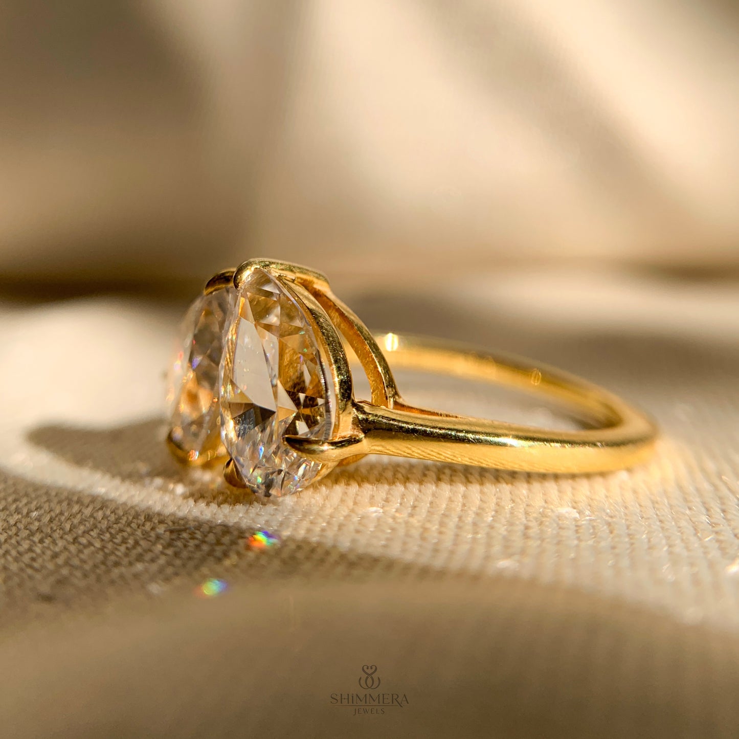 Pear shaped moissanite and round cut accent engagement ring in white gold