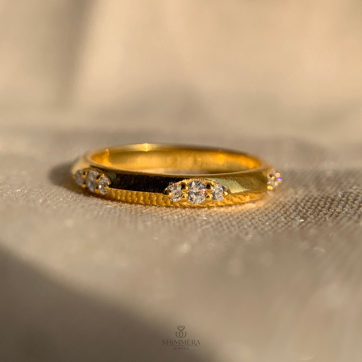 Women’s flush set wedding band featuring round diamonds
