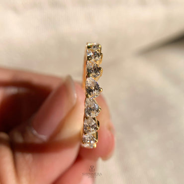 Elegant pear cut diamond eternity ring with criss-cross design