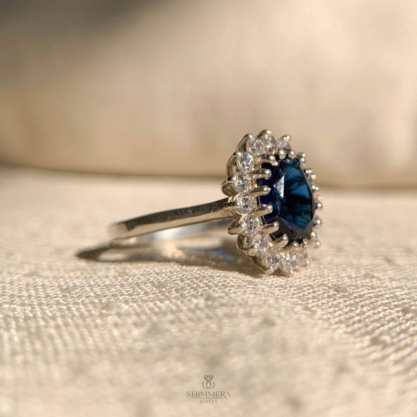 Vintage style oval cut blue sapphire ring with side stones