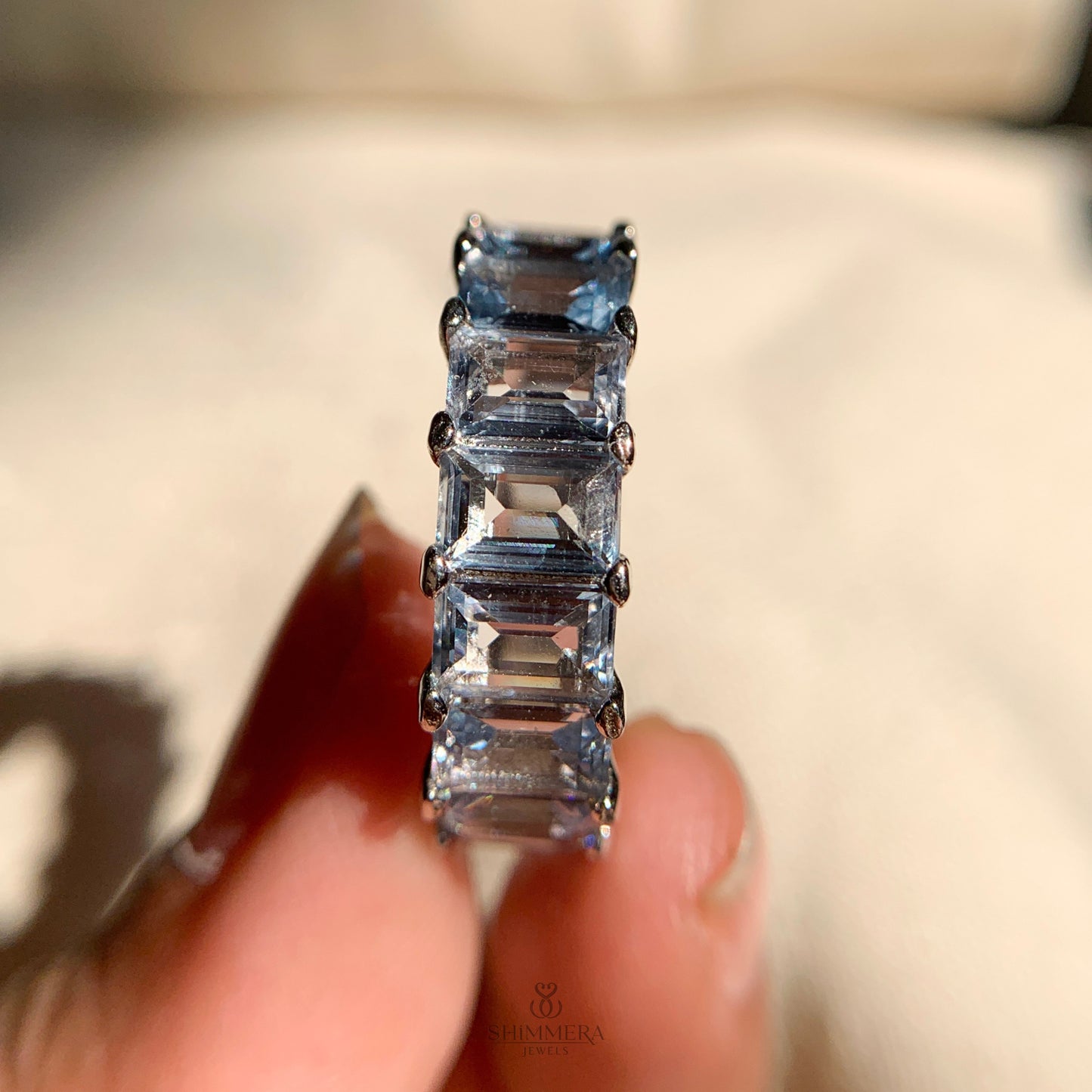 Elegant rose gold band featuring round aquamarine stones all around