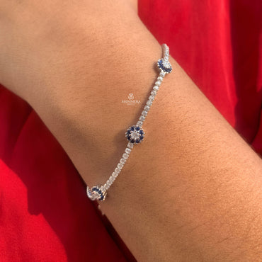 Classic tennis bracelet featuring round sapphire and diamond stones