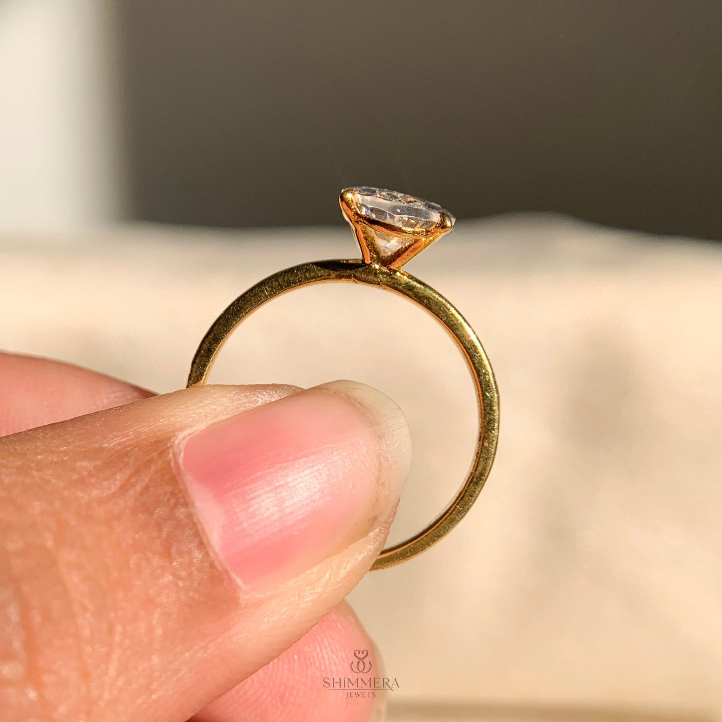 Oval shaped solitaire engagement ring in 14k yellow gold