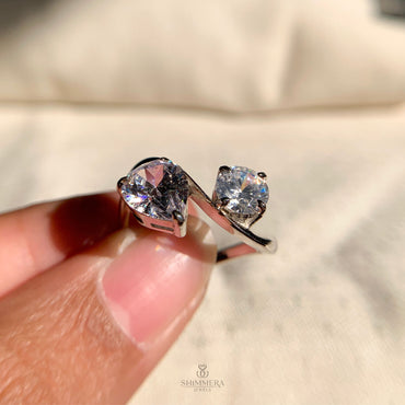 Toi et Moi engagement ring with round and pear diamonds in a luxurious setting