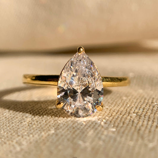 Moissanite pear shaped solitaire engagement ring in classic white gold setting