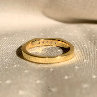 Elegant five diamond wedding band in yellow gold setting