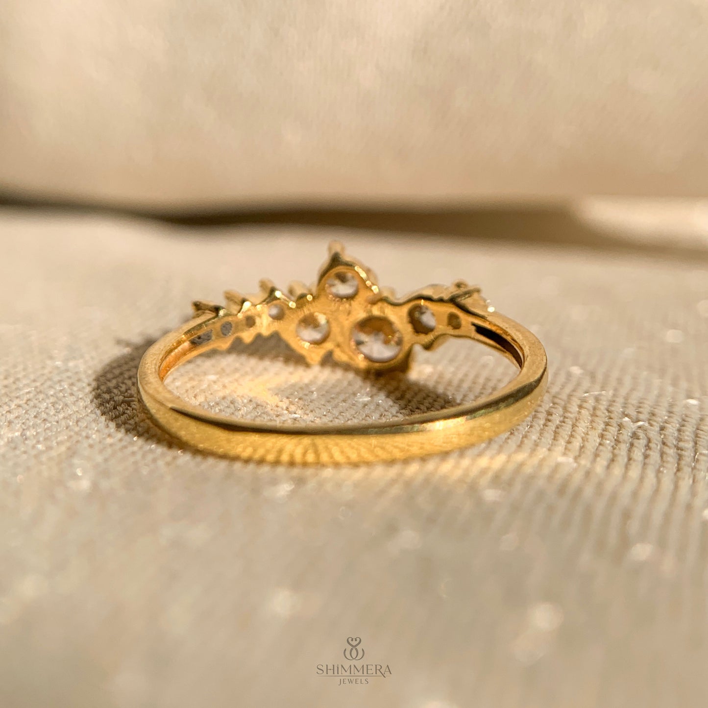 Round cut moissanite diamond cluster ring set in polished gold band