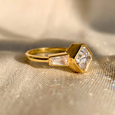 Modern bezel set Asscher cut diamond with baguette side stones engagement ring