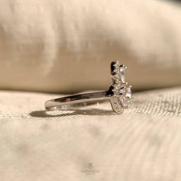 Elegant pear shaped lab grown diamond ring with three stone halo design