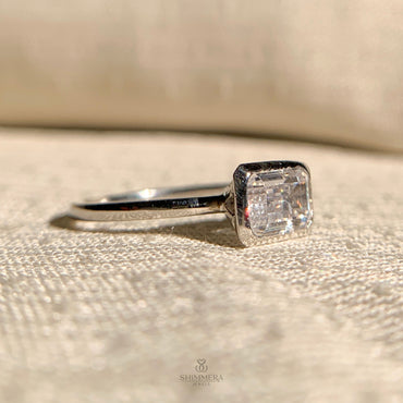 “Modern emerald cut diamond east-west engagement ring for minimalist brides”