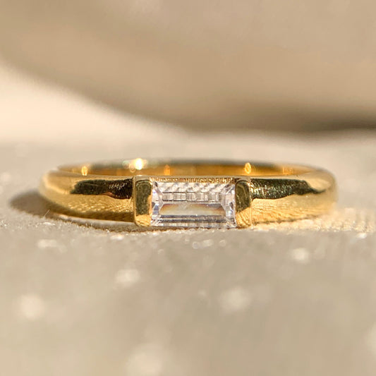 East-West solitaire baguette diamond wedding band in sleek gold setting