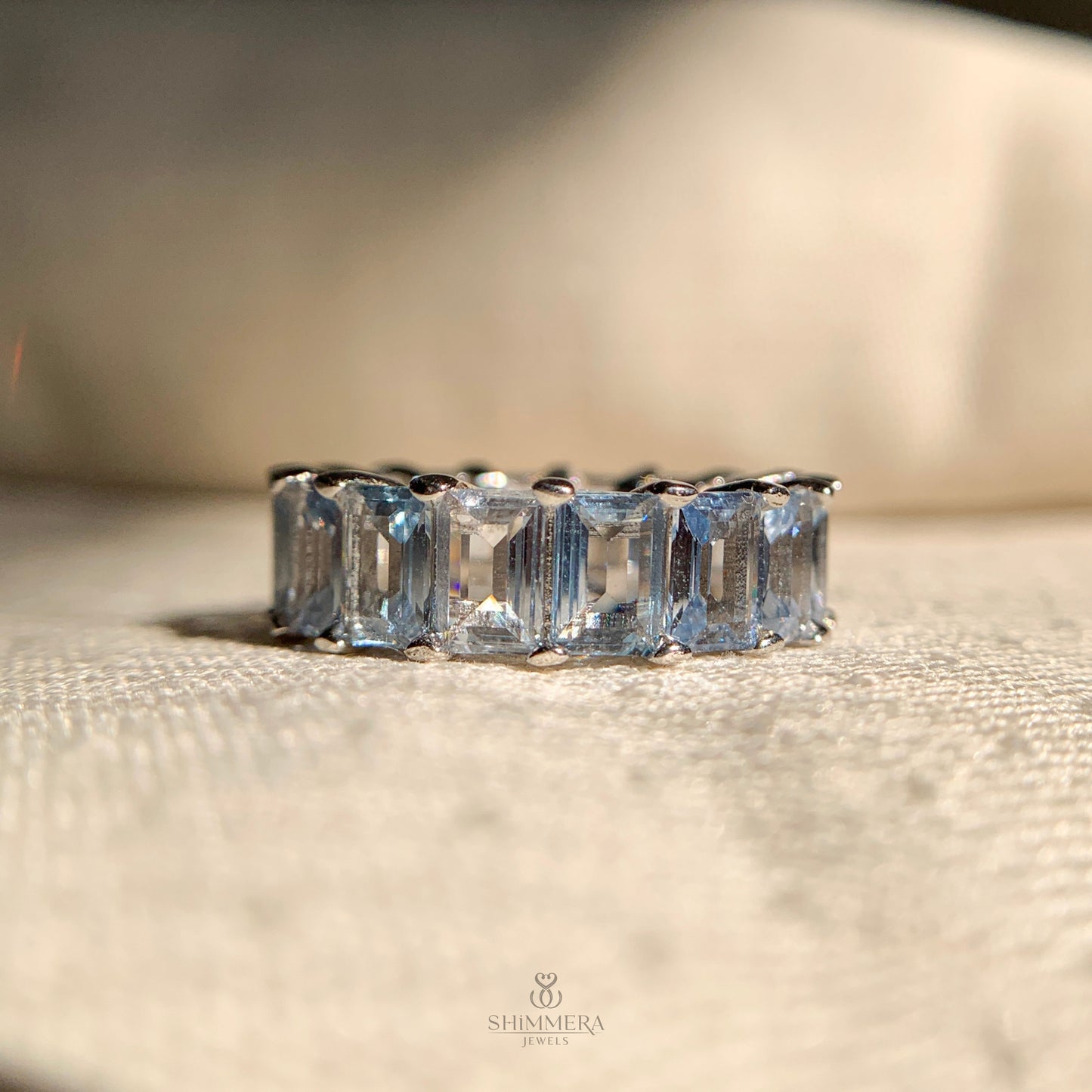 Women’s aquamarine rose gold eternity ring for wedding or anniversary