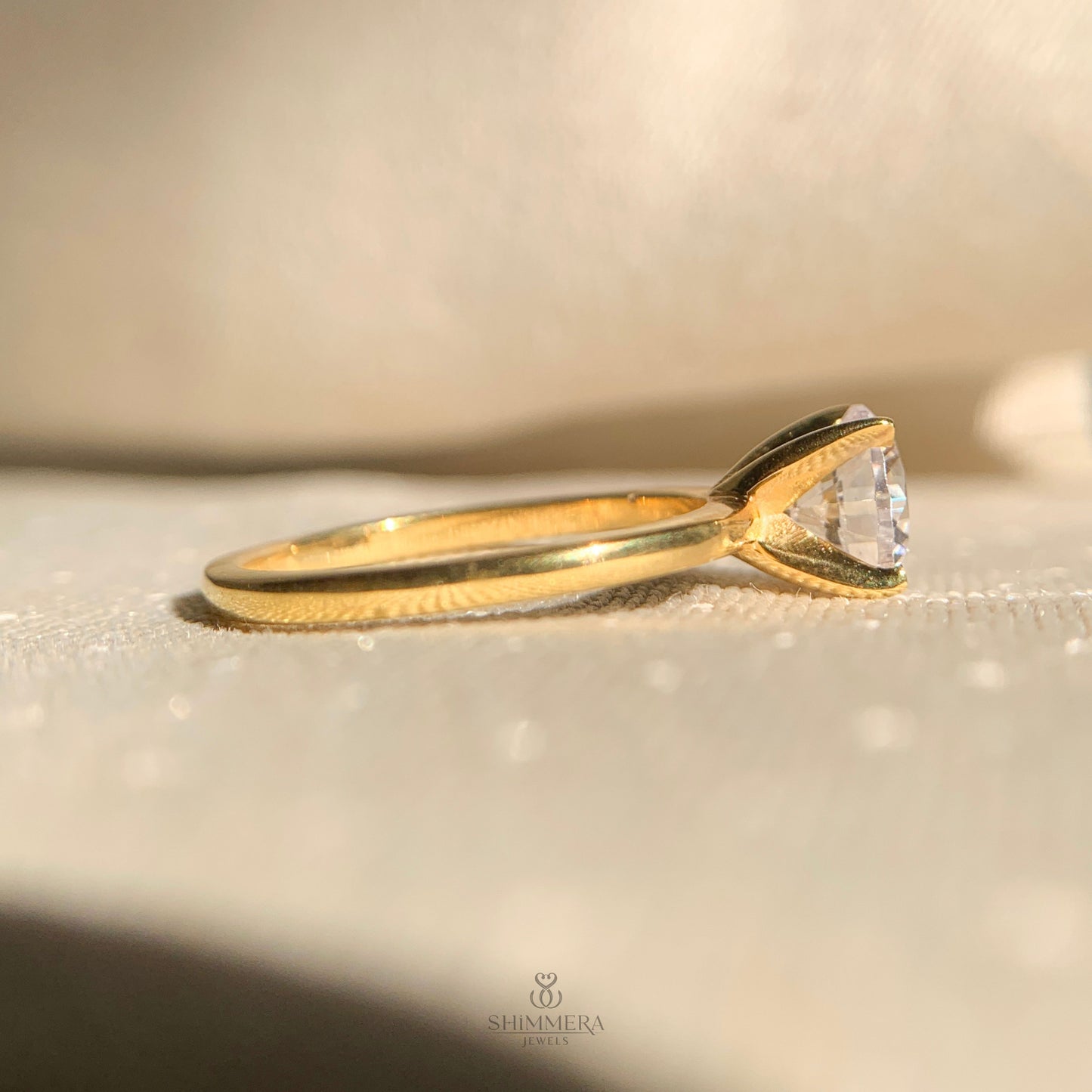 “Classic solitaire engagement ring featuring 1.5 carat round diamond stone”