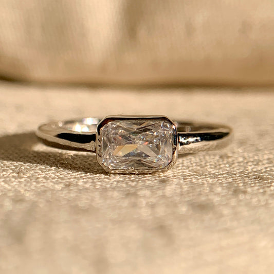 "East-West radiant cut solitaire engagement ring in white gold"