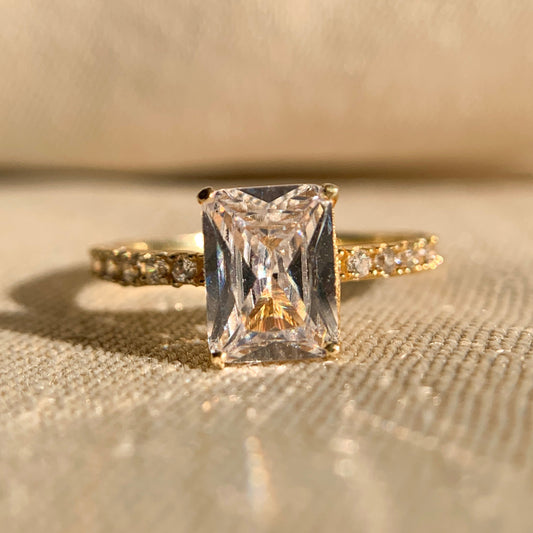 “1.0 CT radiant cut diamond engagement ring with sparkling side stones in classic setting”