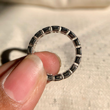 Close-up of radiant cut bezel set wedding band with sparkling diamonds