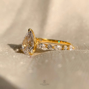 Pear Shaped Diamond Engagement Ring With Marquise Side Accents