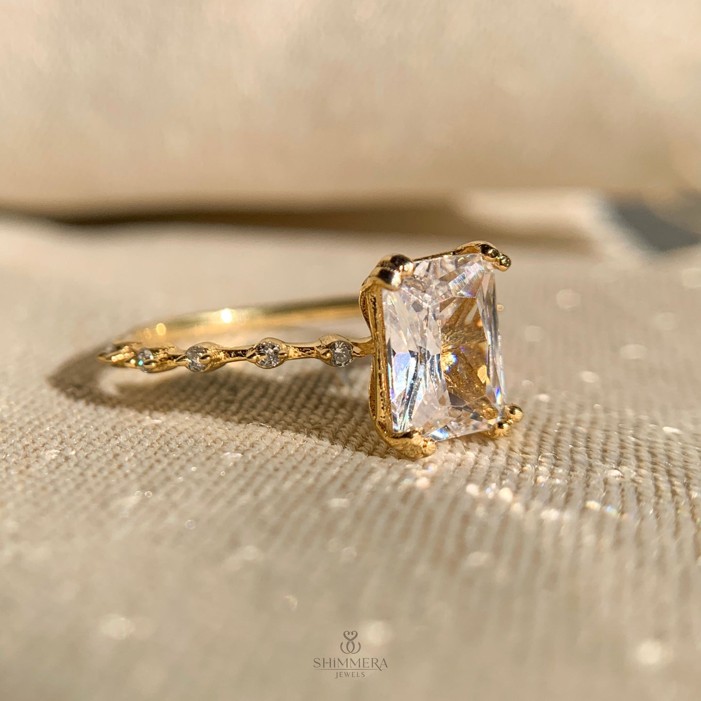 Radiant cut solitaire style ring enhanced with side diamonds for extra brilliance