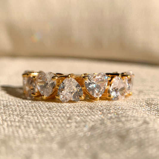 Halfway wedding band featuring sparkling heart cut moissanite stones