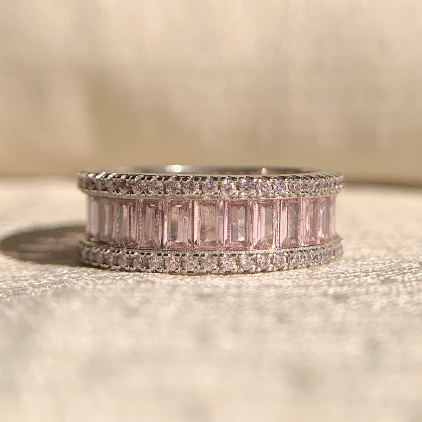 Elegant pink baguette diamond wedding band in sleek white gold setting