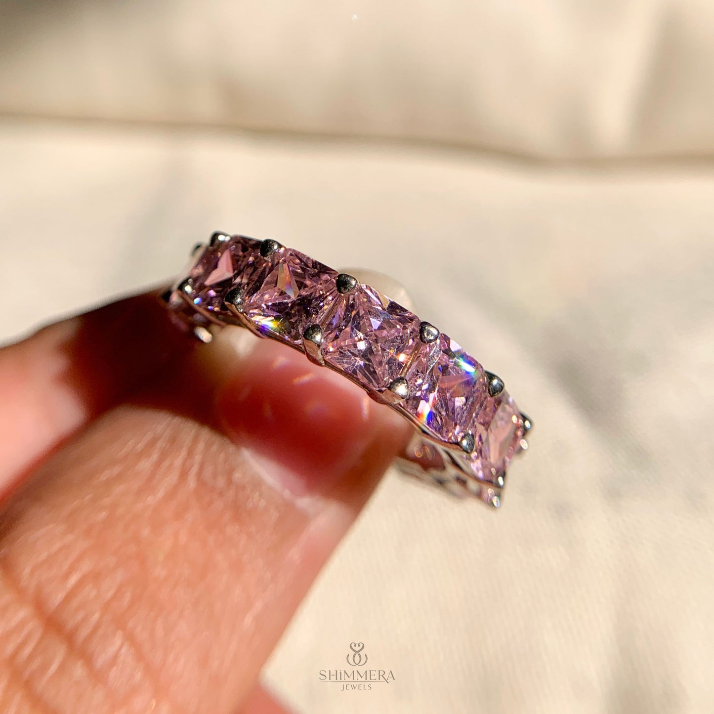 Pink diamond eternity wedding band with sleek sterling silver design