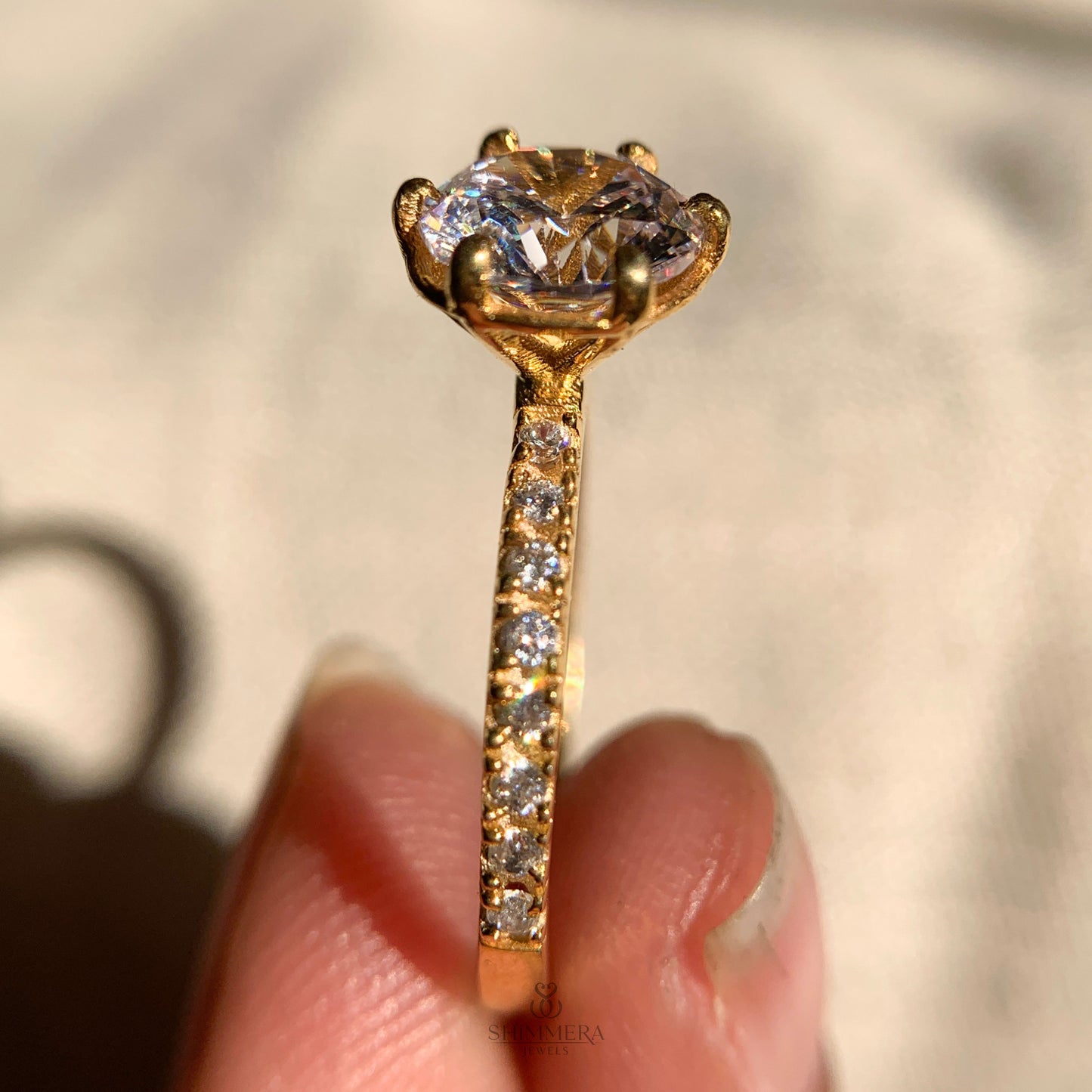 Traditional round brilliant diamond ring in six prong cathedral setting