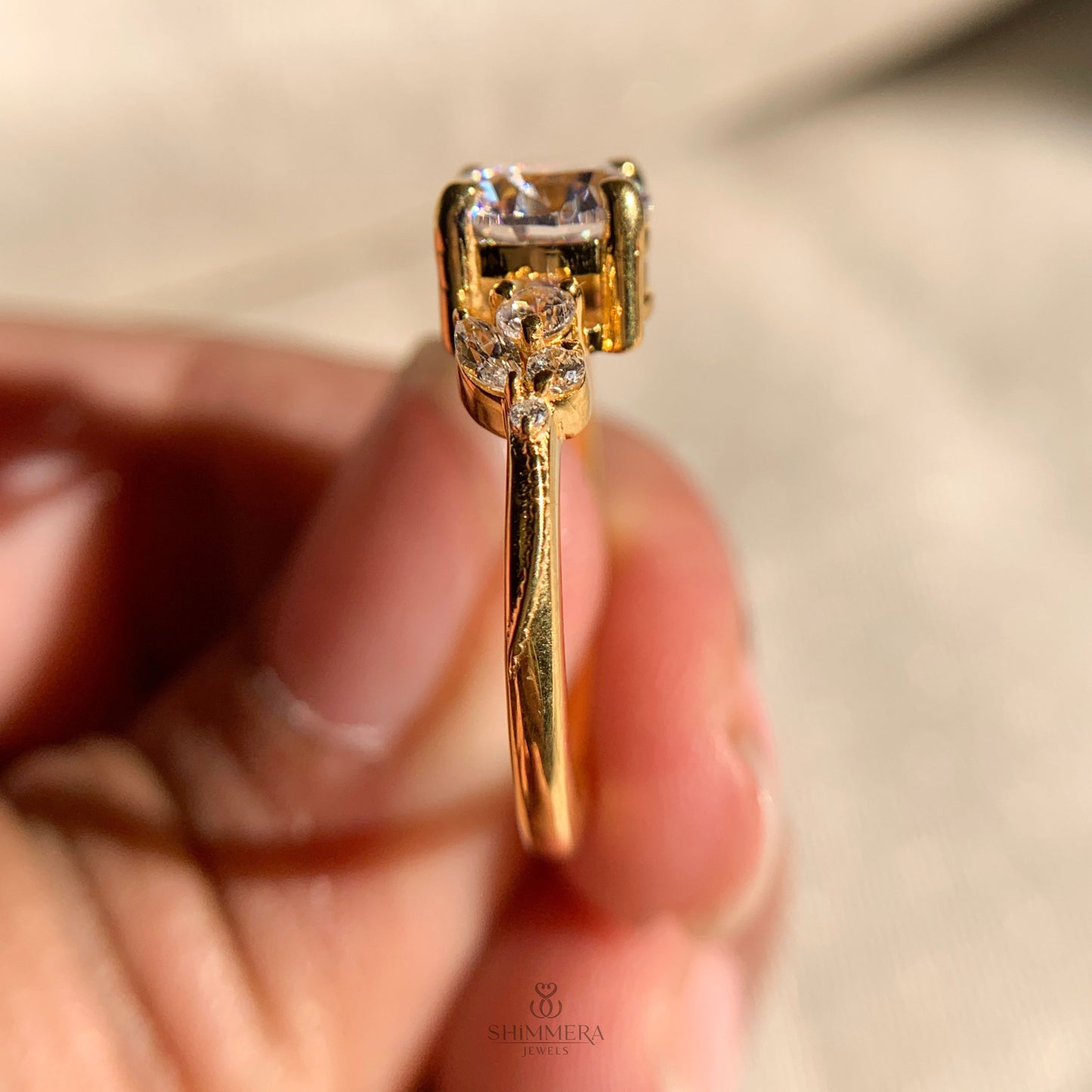 Round center diamond engagement ring surrounded by accent side stones for added sparkle