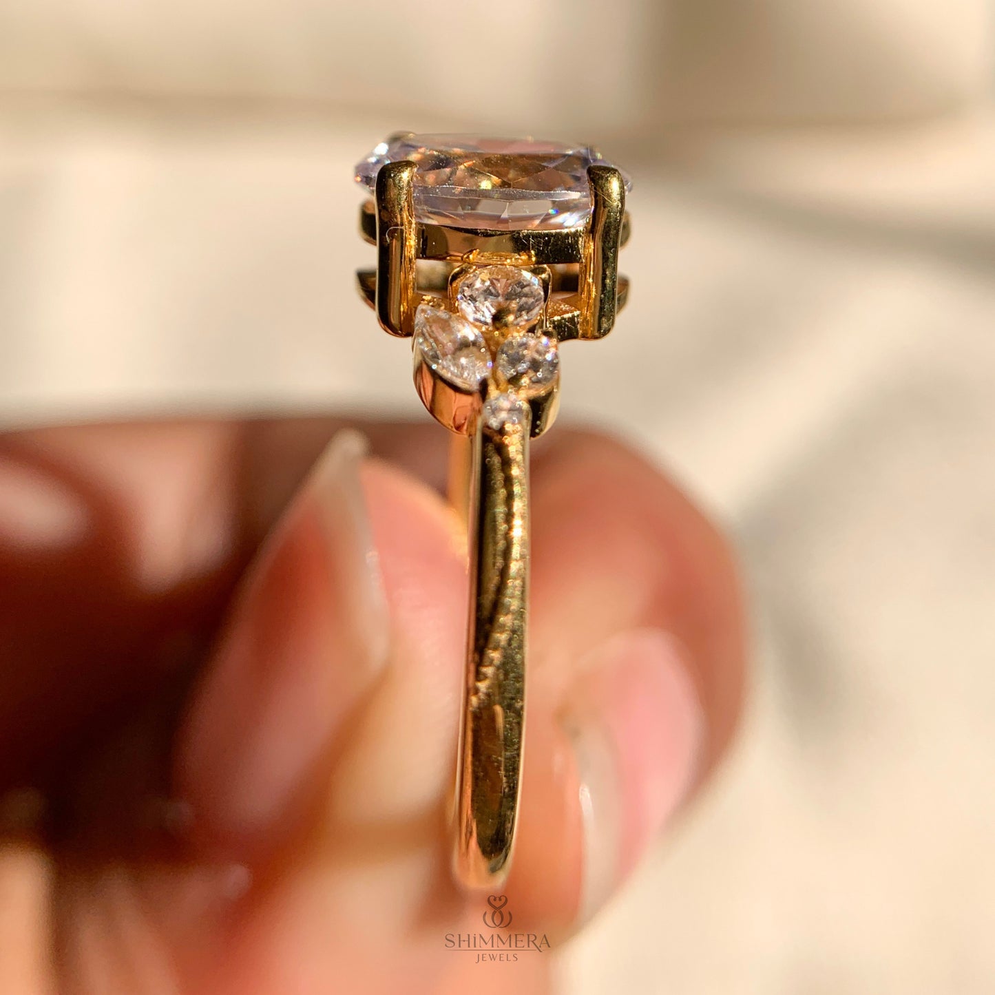 Oval cut diamond side stone ring in solid gold setting
