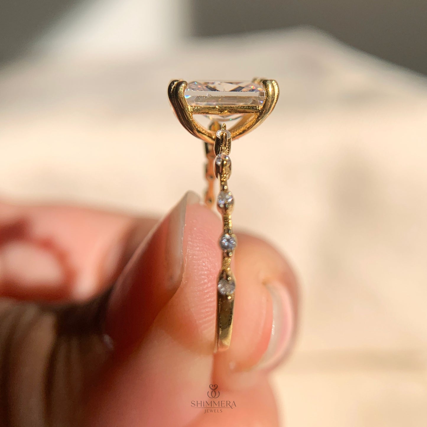 Women’s radiant cut engagement ring with pave side stones in platinum