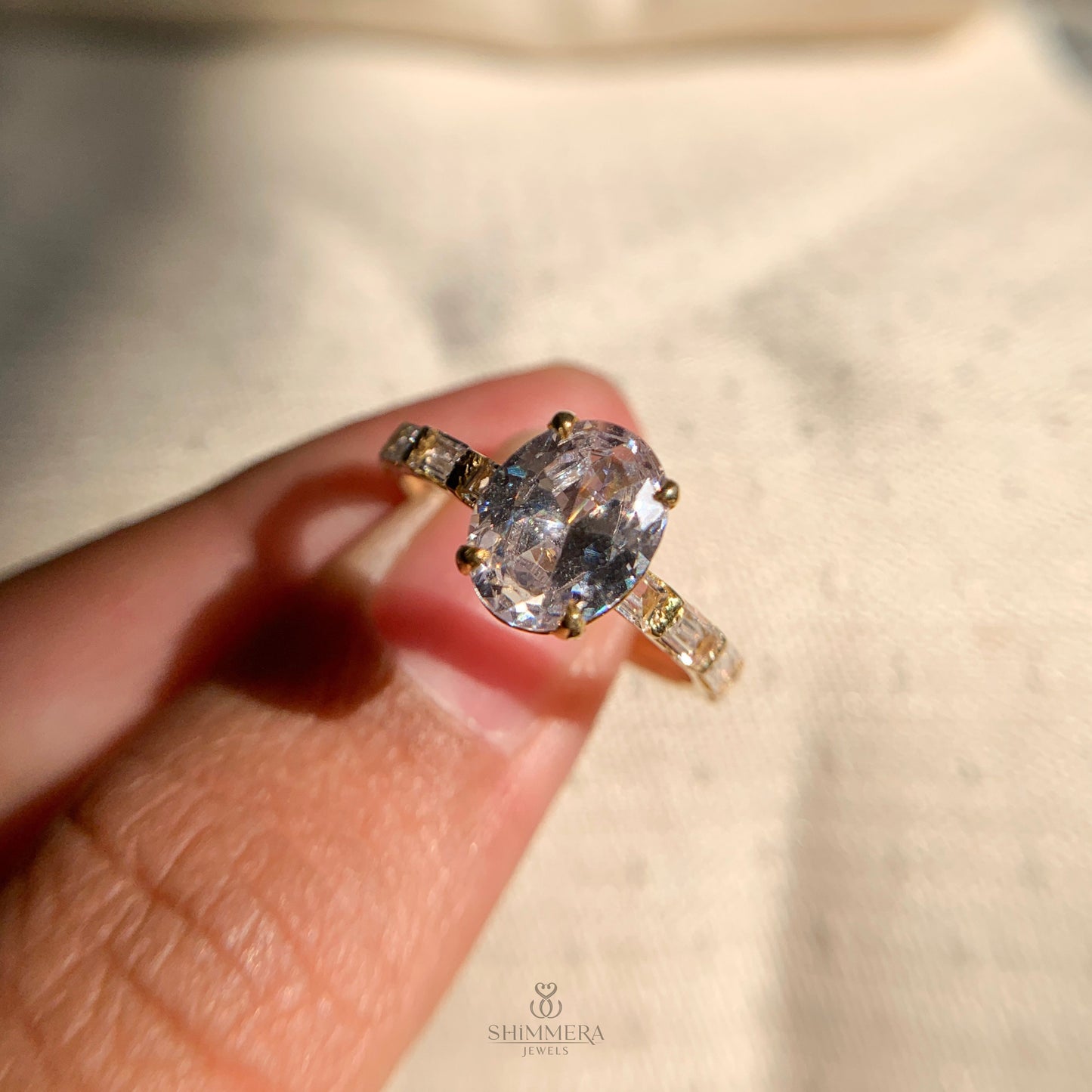Timeless oval moissanite engagement ring in a side-stone setting