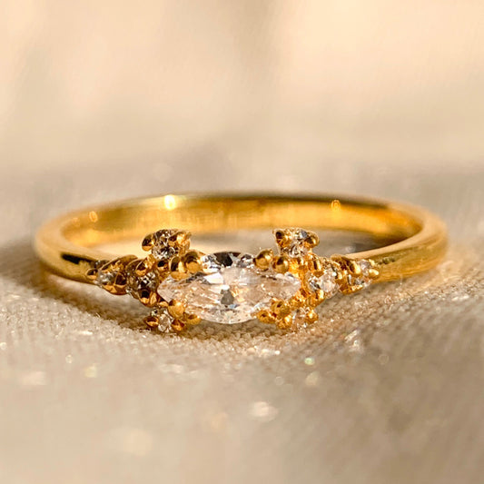 Elegant engagement ring with marquise side stone in white gold