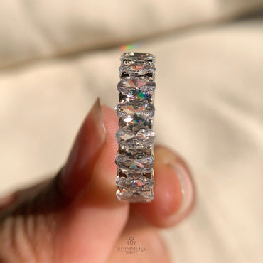 Unique mixed-cut moissanite eternity ring featuring oval and emerald shapes
