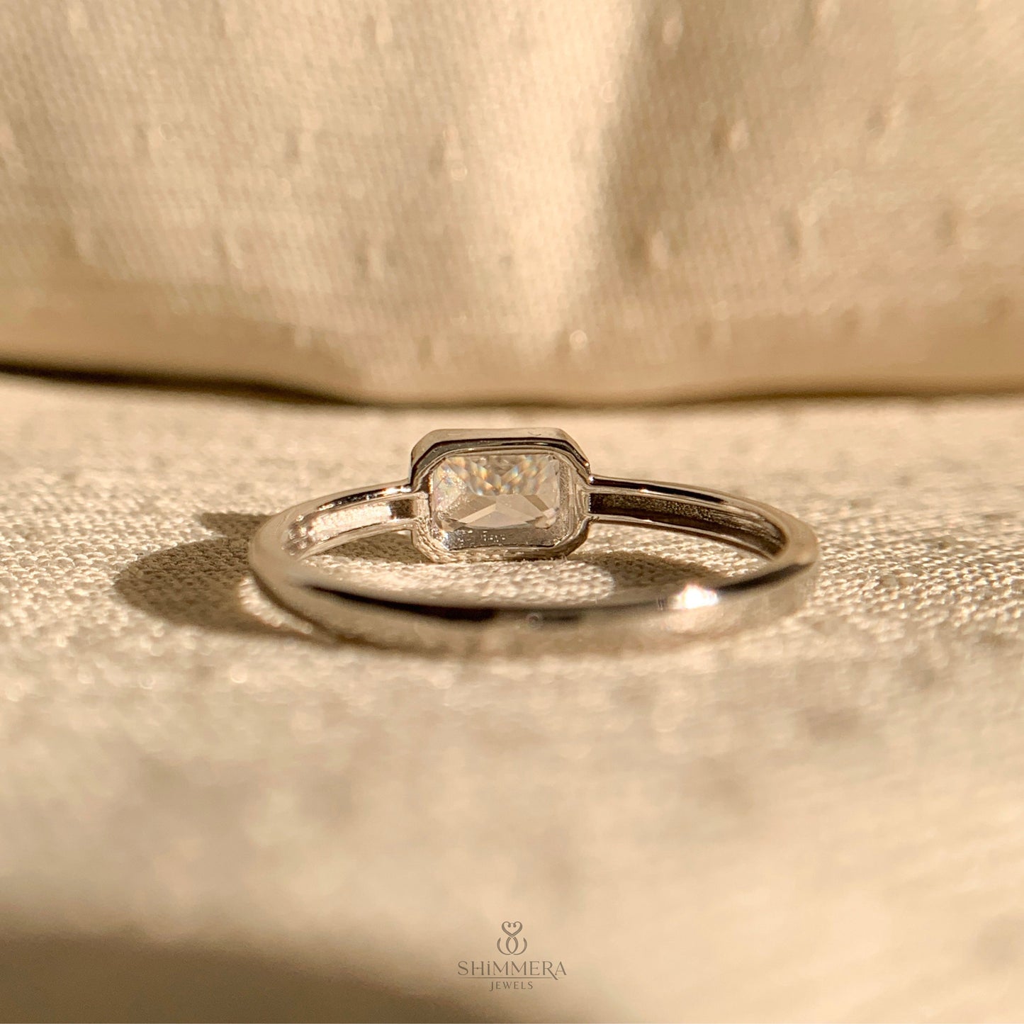 "Unique east-west diamond engagement ring with radiant cut stone"