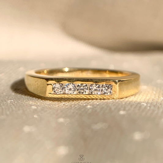 Thin yellow gold ring with five sparkling diamonds