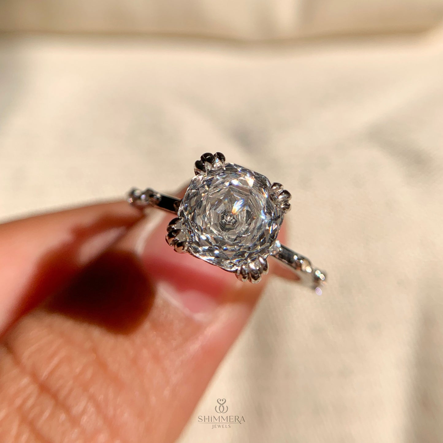 “Cushion cut solitaire engagement ring with secure double claws”