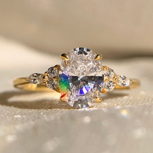 Oval cut diamond engagement ring with side stones in white gold