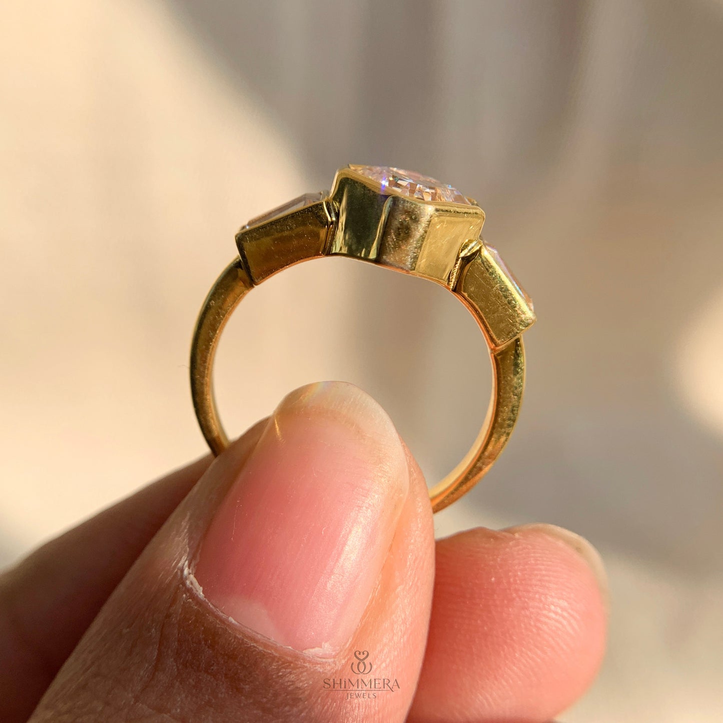 Asscher cut center diamond bezel set with baguette accents for timeless elegance