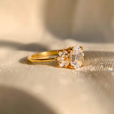 “Oval cut 1.25Ct engagement ring featuring sparkling marquise side accents”