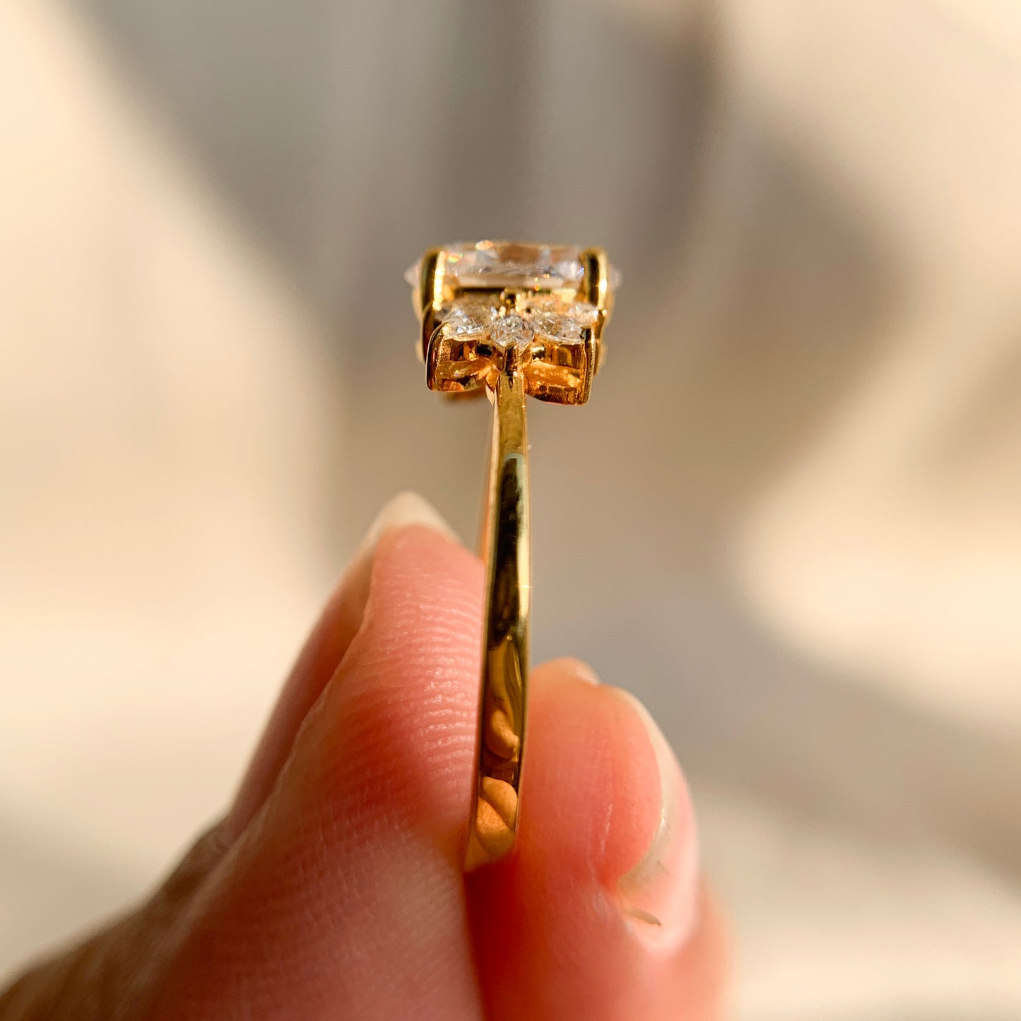 “Bridal 1.25Ct oval cut ring featuring marquise side stones in sleek setting”