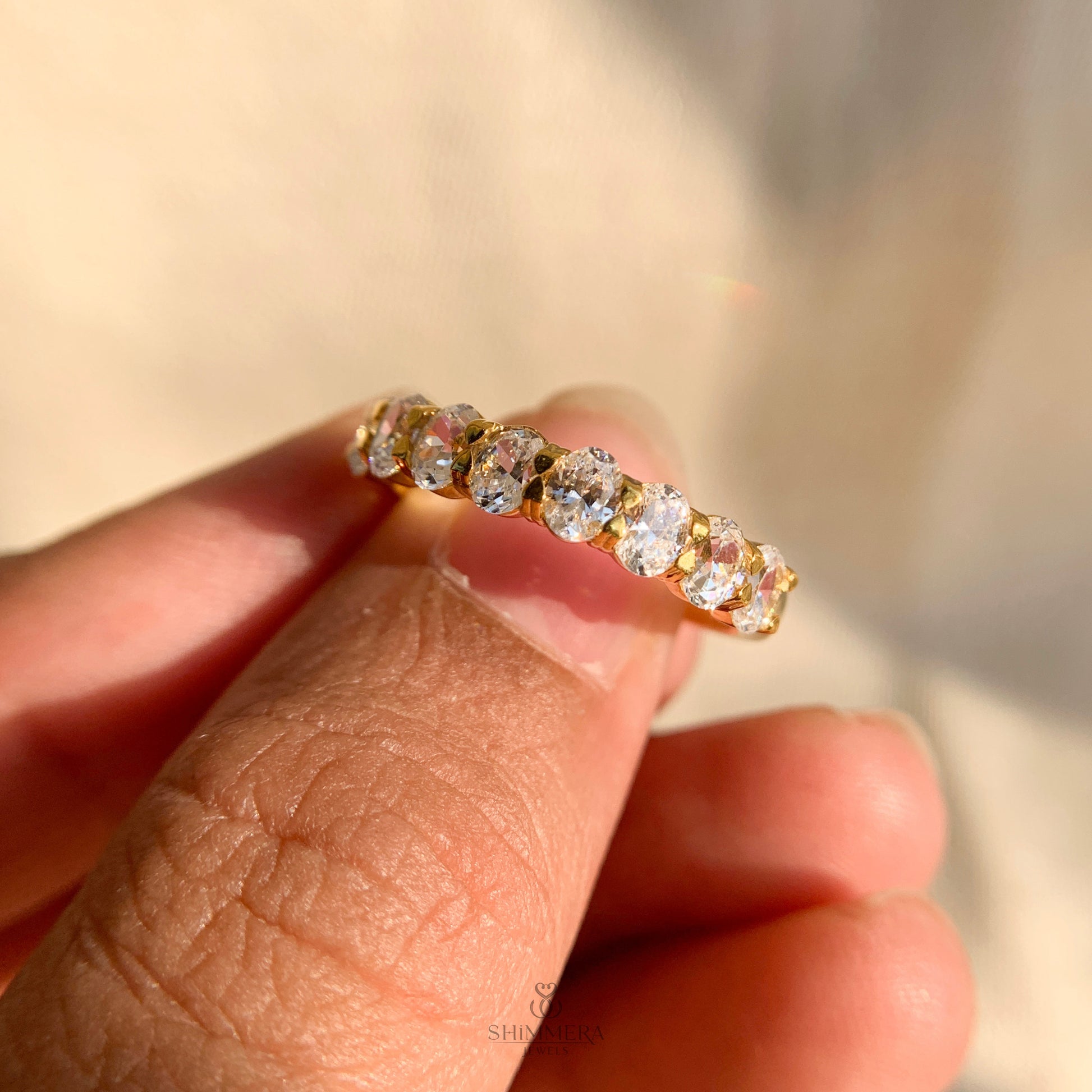 Dainty yellow gold oval cut diamond half eternity ring