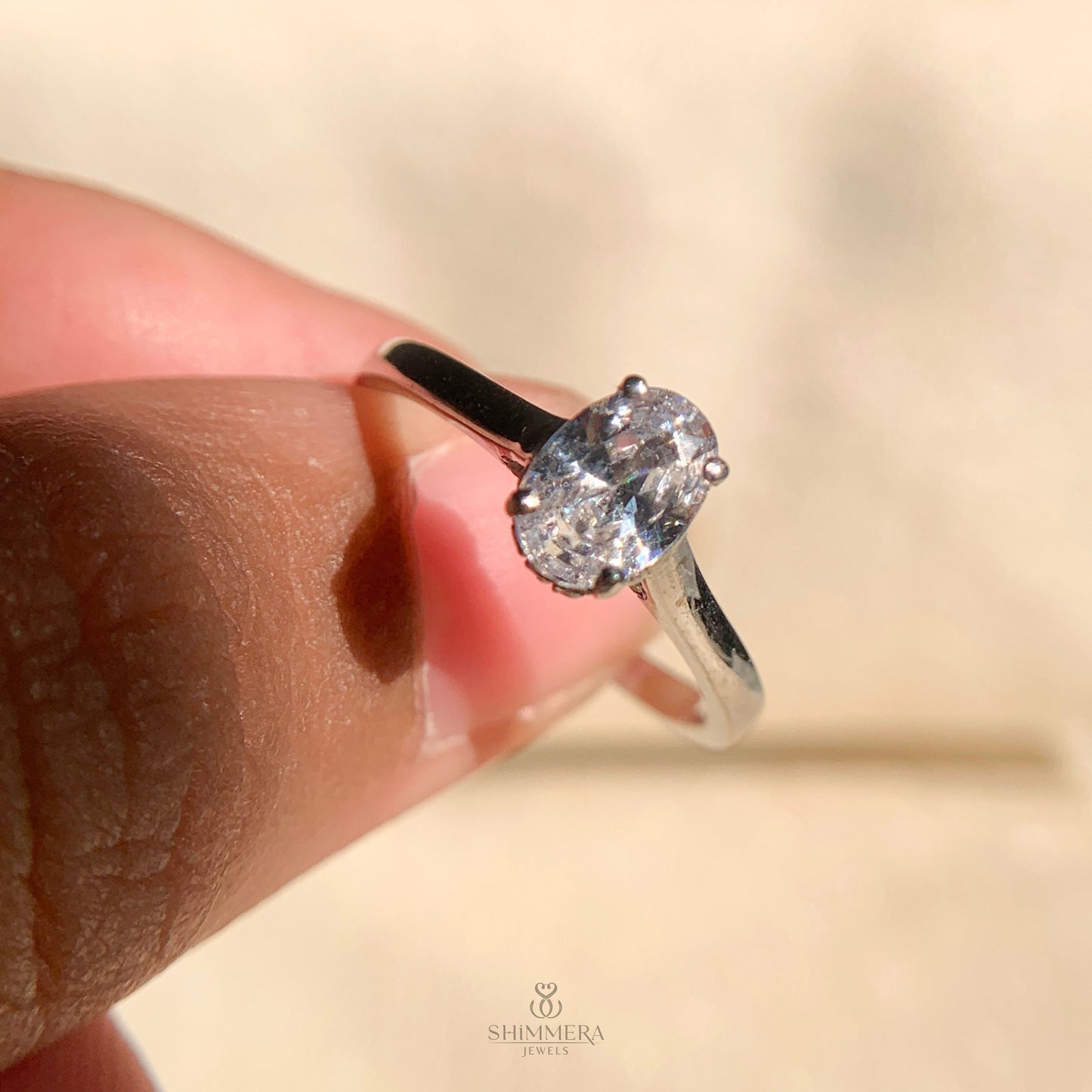 Elegant oval diamond solitaire ring set in 14k white gold